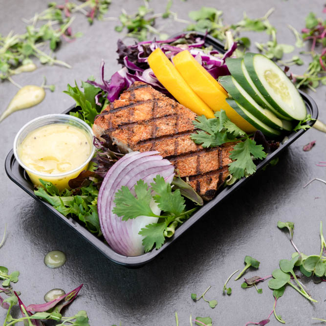 Seared Tuna Steak.  Served on a Bed of Organic Spring Greens with Sliced Cucumber, Yellow Peppers & Red Onions.  Sided with Our Champagne Vinaigrette Dressing